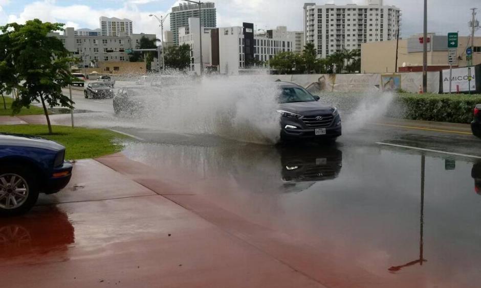 An SUV splashes down Miami Beach's Alton Road Sunday morning. Photo: David J. Neal
