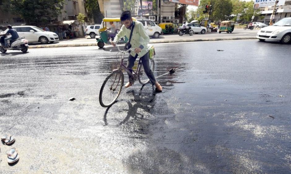 File photo: A cyclist in Ahmedabad struggles as tar melts on a road in summer last year. Photo: Yogesh Chawda, BCCL Ahmedabad