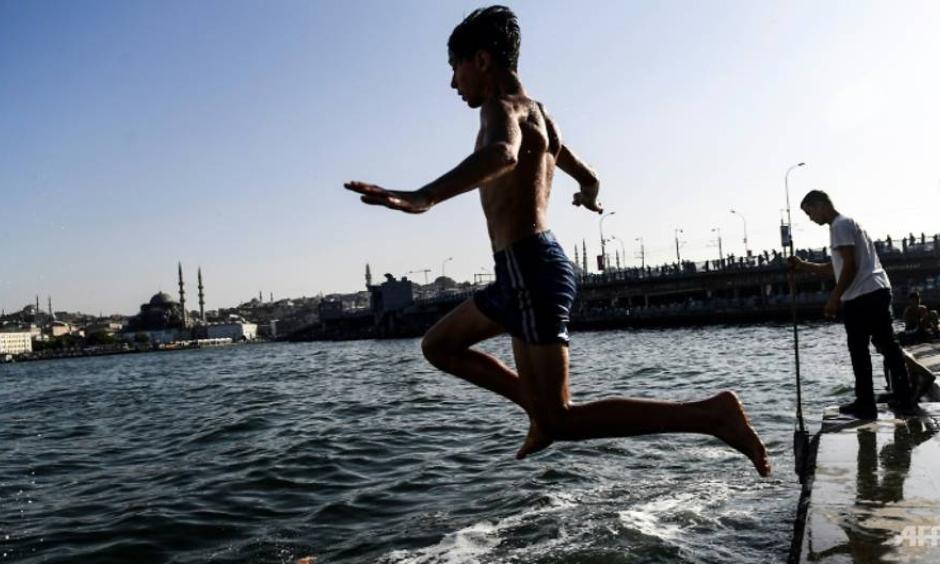 In Istanbul, many people took a dip in the Bosphorus to cool down. Photo: Bulent Kilic, AFP