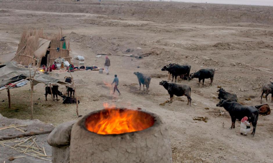 An oven burns near a family's reed hut in Chibaish, Iraq. The family moved to this area in search of water, but much of the former marshes remain desolate after years of draining and neglect. Photo: Carolyn Drake, Magnum