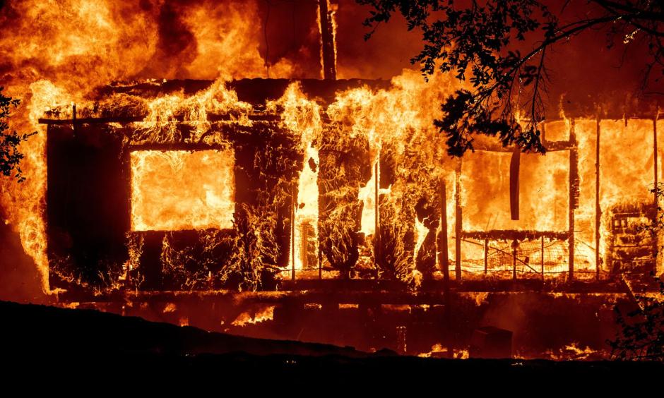 Flames consume a home as the Kincade Fire tears through the Jimtown community of Sonoma County, Calif. Credit: Noah Berger/AP