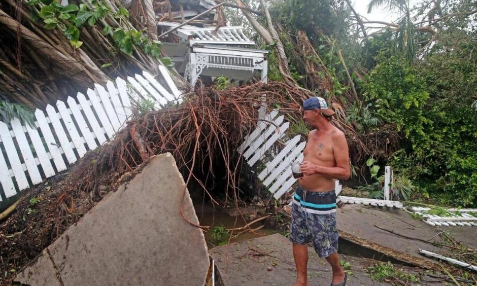 Robert Phillips looks at the former Key West house of poet and author Shel Silverstein, which was crushed by a falling tree as Hurricane Irma swept through, September 10, 2017. Photo: Charles Trainor, Jr.