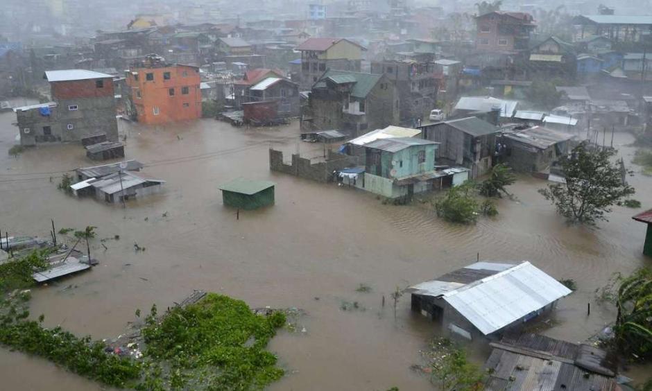 Houses, partially submerged in floods waters caused by heavy rains brought by Typhoon Koppu, are seen in City Camp Lagoon at Baguio city, north of Manila October 19, 2015. Typhoon Koppu swept across the northern Philippines killing at least nine people as trees, power lines and walls were toppled and flood waters spread far from riverbeds, but tens of thousands of people were evacuated in time. (REUTERS/Harley Palangchao)