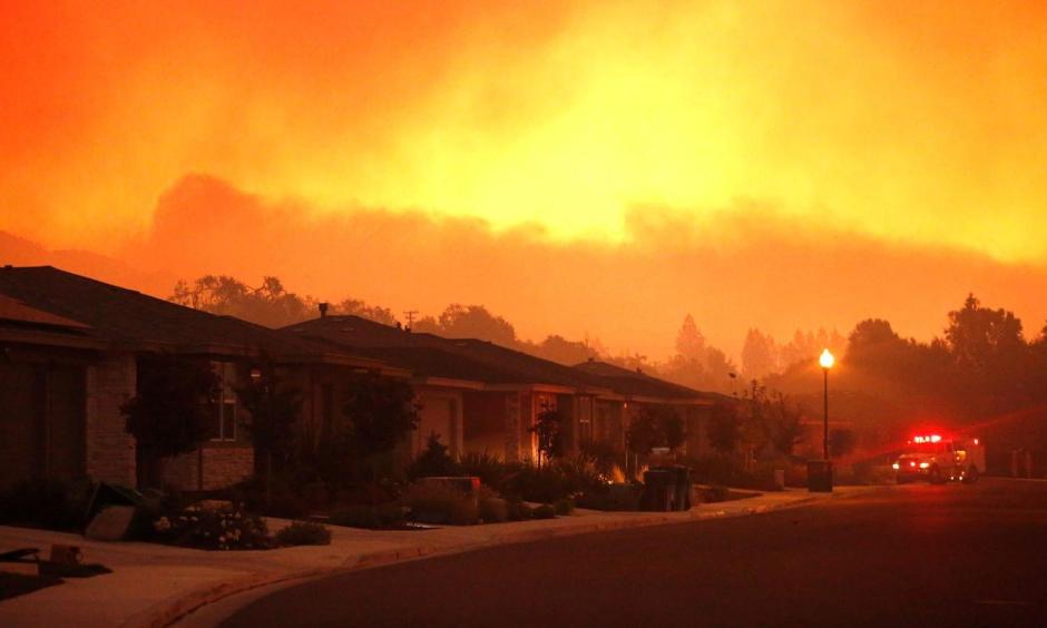 Firefighters monitor flames threatening the Oakmont community along Highway 12 in Santa Rosa. Photo: Genaro Molina / Los Angeles Times