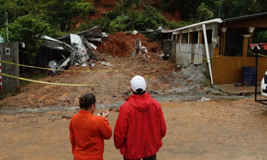 Panamanian civil defense workers view a mudslide that destroyed a home and killed the couple inside in Arraijan, on the outskirts of Panama City on Tuesday. Photo: Associated Press