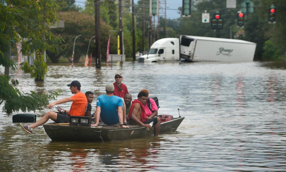 A small boat transports flood victims down Old Hammond Highway in east Baton Rouge on Aug. 14, 2016. Photo: Travis Spradling, The Advocate