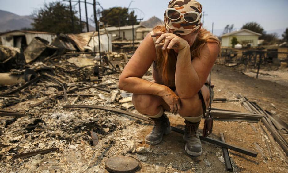 Tyra Rene Fuller tears up a she finds a porcelain cast of her daughter's handprint while soring through what's left of her belongings after her home was destroyed by the Erskine fire in Lake Isabella, Calif. Photo: Marcus Yam / Los Angeles Times