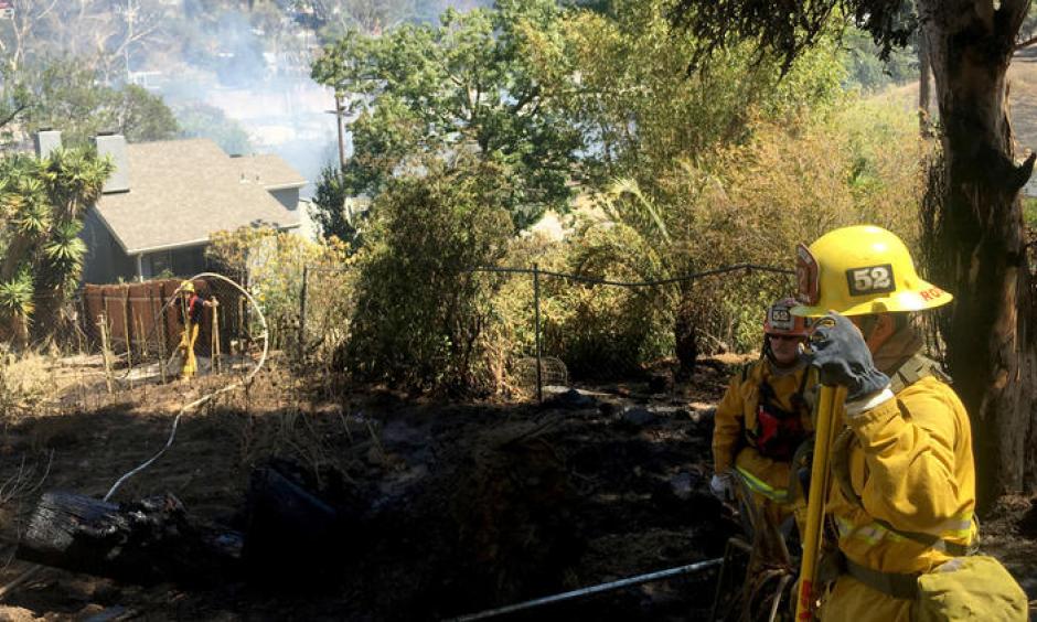 In Silver Lake, a fire at a home quickly spread to brush along the 2 Freeway, prompting firefighters to call for more resources and air support. The freeway was closed in both directions near its terminus in Echo Park. Photo: Dillon Deaton / Los Angeles Times