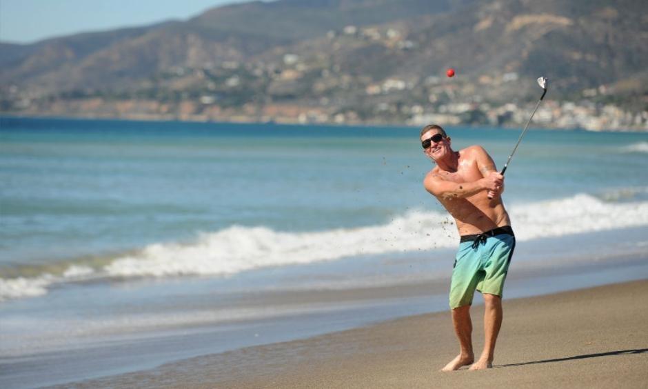 Dan Charcoal, who is vacationing in Southern California from Maui, golfs on Zuma Beach during a hot winter day Monday. Photo: Wally Skalij, Los Angeles Times
