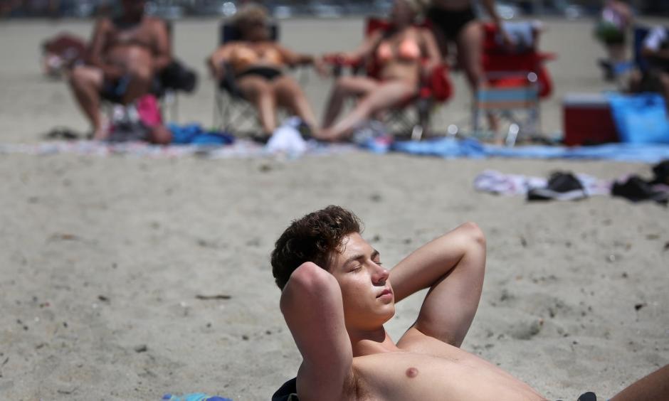 Jack Amsbry, 18, of Pasadena enjoys a warm beach breeze on Sunday in Long Beach. Photo: Rick Loomis / Los Angeles Times