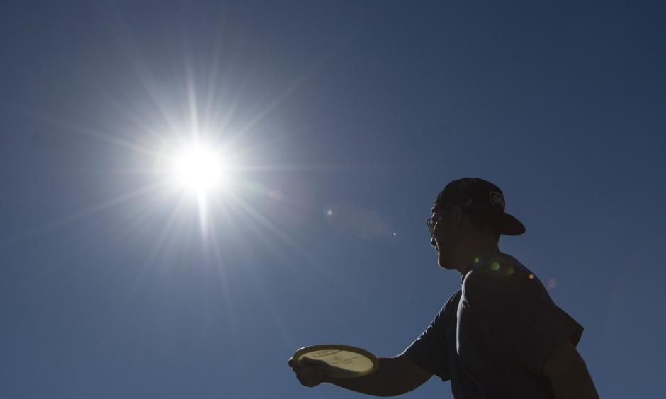 Ian Kellam of Costa Mesa fires a shot as he and friends play disc golf at a course in Huntington Beach earlier this month. Southern California has seen above-average heat in February so far. Photo: Ed Crisostomo, AP