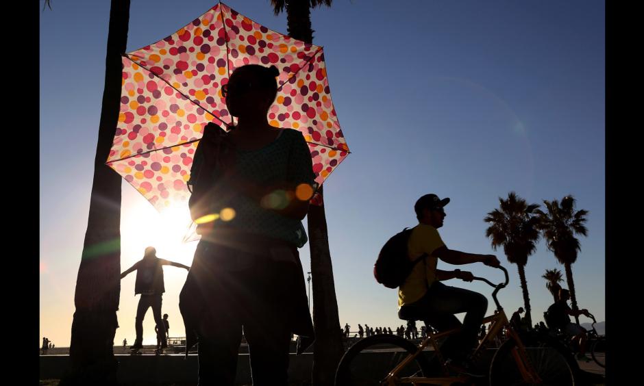 Ariel Rhone uses an umbrella for shade near the Venice boardwalk on Monday. Photo: Katie Falkenberg, Los Angeles Times