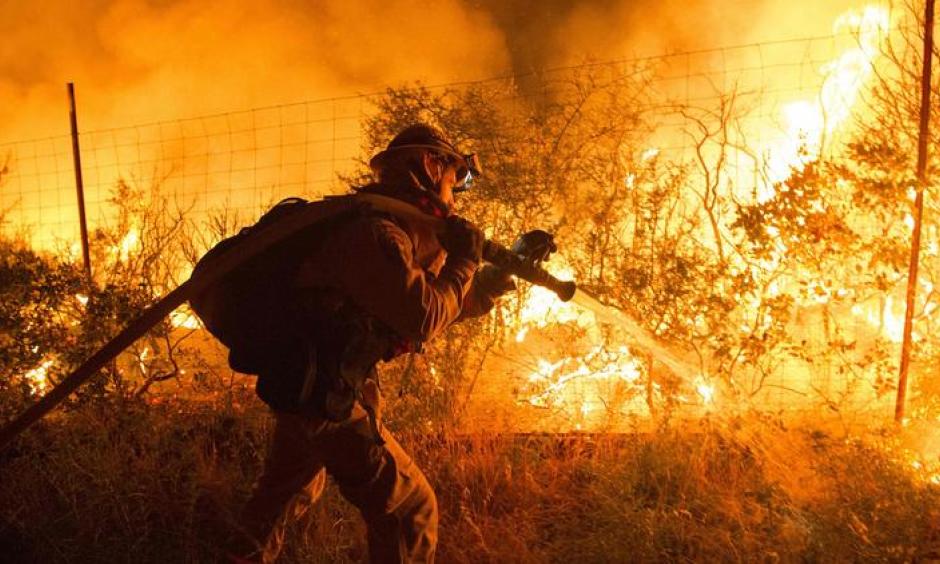 Firefighters attempt to control flames as they approach a vineyard in the Santa Cruz Mountains. Photo: Josh Edelson, AFP, Getty Images
