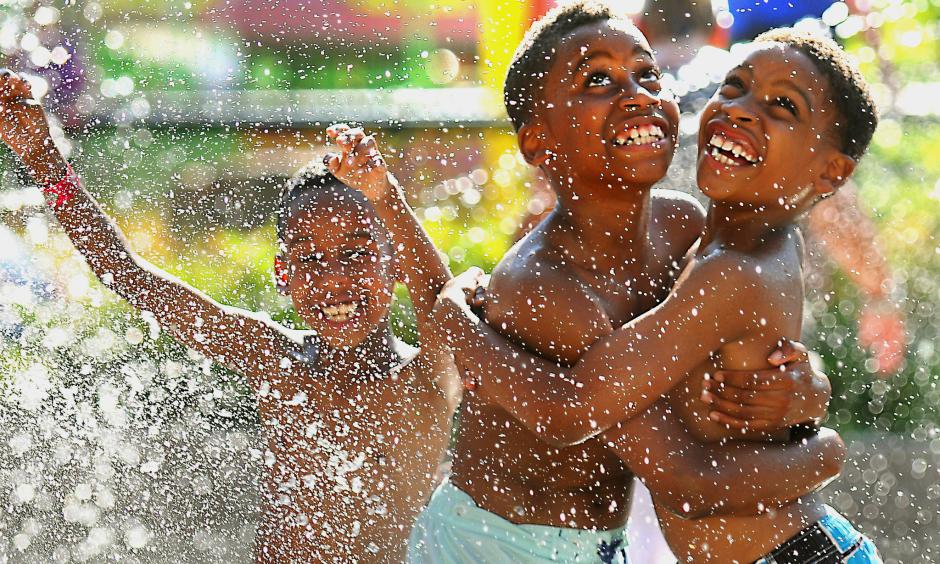 Nine-year-old William Williams, right, and his brother Xavier Robertson, 10, wait for the Big Splash machine at the Como Town water park to dump water on them in St. Paul, Minn. Temperatures hit 92 degrees in St. Paul on Wednesday, with a heat index of 97 degrees. Photo: John Autey / Associated Press