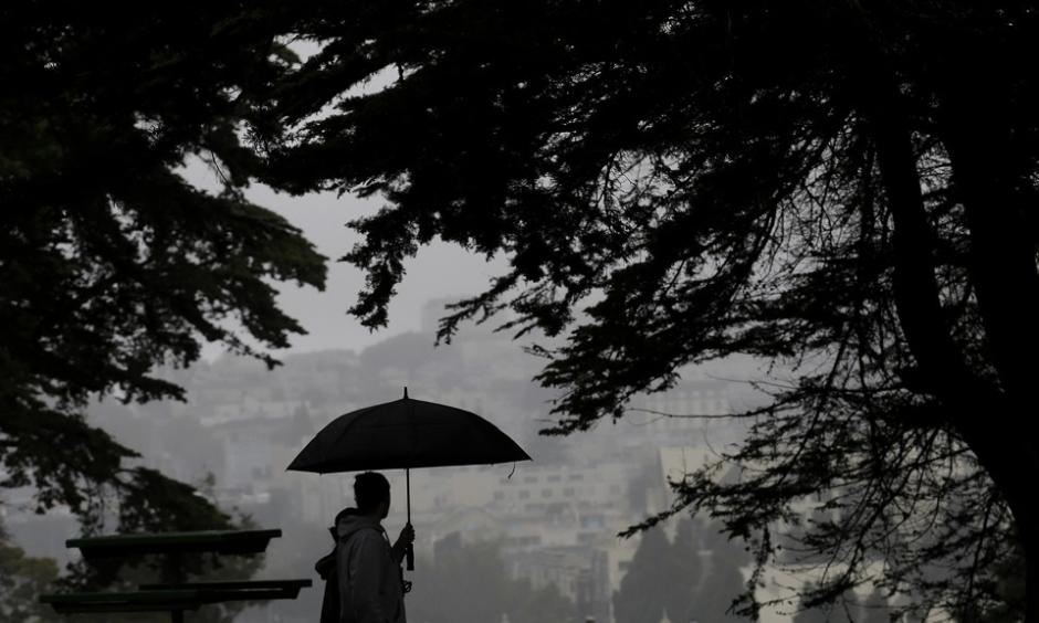 A man and a woman walk together in Alamo Square Park in San Francisco on Thursday evening. Photo: Jeff Chiu, AP