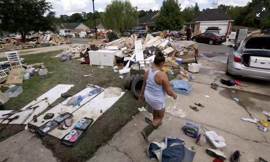 A resident walks through a flood-damaged neighborhood in Louisiana. The state’s governor has requested an addition $2bn in emergency aid from the federal government. “Simply put, we cannot recover without it,” Edwards said at a House subcommittee hearing. Photo: Jonathan Bachman/Reuters