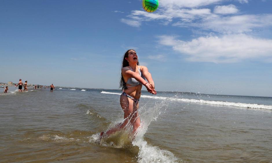 Nessa King of Wyndham, Maine, returns a shot while playing volleyball in record breaking heat at Old Orchard Beach, Maine, Thursday, May 18, 2017. King was one of hundreds of Maine high school seniors who skipped school to enjoy a day at the beach with classmates. Photo: Robert F. Bukaty, AP