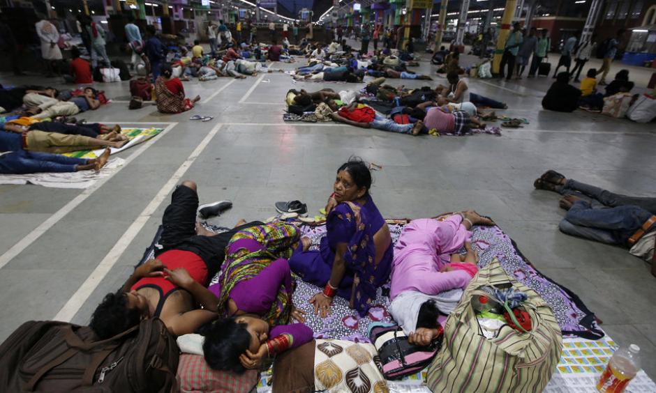 Stranded passengers in a railway station in Kolkata, India, in May after trains were canceled because of Cyclone Fani. Photo: Rupak De Chowdhuri, Reuters