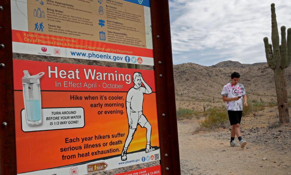 A morning walk at the South Mountain Preserve in Phoenix last month. Afternoon highs in Phoenix last summer averaged 106 degrees Fahrenheit, almost 3 degrees hotter than the average for the second half of the 20th century. Credit: Matt York, Associated Press