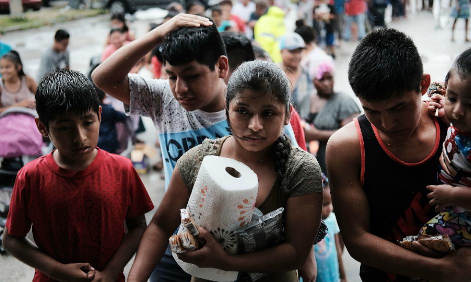 A line of residents of the rural migrant farm worker town of Immokalee, Florida, waited for emergency donations of food and supplies brought in by a volunteer group from Georgia. Hurricane Irma damaged homes, flooded their community and wiped out jobs they rely on. Photo: Spencer Platt, Getty Images