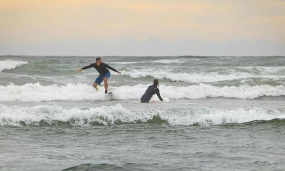 Taking advantage of Nahant Beach’s waves on Labor Day morning were Nels Nelson of Somerville and Odette Bakker, visiting from the Netherlands. Photo: Dina Rudick, Globe Staff