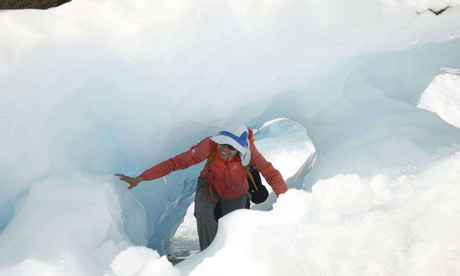 In this Feb. 6, 2016 photo, tourists who have taken a helicopter trip onto the Fox Glacier climb through a hole in the ice in New Zealand. The Fox and Franz Josef glaciers have been melting at such a rapid rate that it has become too dangerous for tourists to hike onto them from the valley floor, ending a tradition that dates back a century. Photo: Nick Perry, AP
