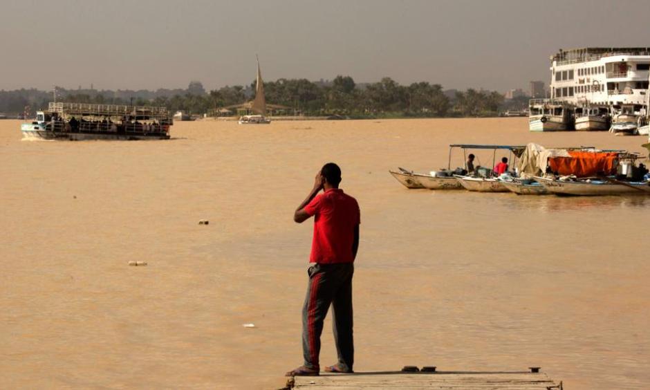 An Egyptian fisherman stands watching the Nile River as water appears a murky brown color due to the flooding in southern provinces, Beni Suef and Sohag south of the capital, in Cairo, Egypt, Tuesday, Nov. 1, 2016. Photo: Amr Nabil, AP