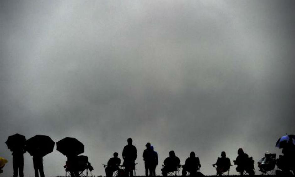 Spectators brave the rain to watch the qualifying session ahead of the the U.S. Formula One Grand Prix at the Circuit of the Americas in Austin, Texas, on Oct. 25, 2015. Photo by Jewel Samad/AFP/Getty Images