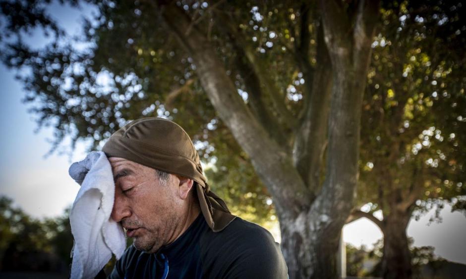 Facing temperatures in the 90s, Guillermo Salazar of Reseda takes a break from mountain biking at San Vicente Mountain Park in Los Angeles last month. Credit: Allen J. Schaben, Los Angeles Times