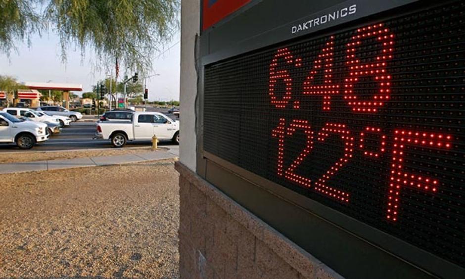 Motorists stop at an intersection where a sign displays the temperature on June 20, 2017 in Phoenix, Arizona. The Phoenix airport hit 119° that day, their fourth hottest temperature on record, and just 3° below their all-time hottest temperature ever recorded. Photo: Ralph Freso, Getty Images