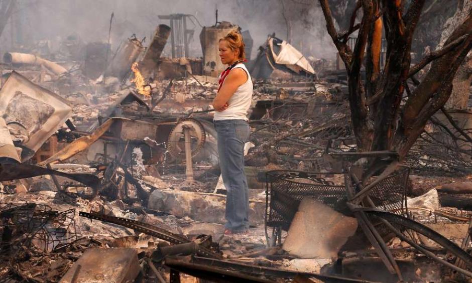 Terrie Burns stands in the middle of her destroyed at the scene of the Tubbs Fire in Santa Rosa, Ca., on Monday October 9, 2017. Massive wildfires ripped through Napa and Sonoma counties early Monday, destroying hundreds of homes and businesses on Monday October 9, 2017. Photo: Michael Macor, The Chronicle