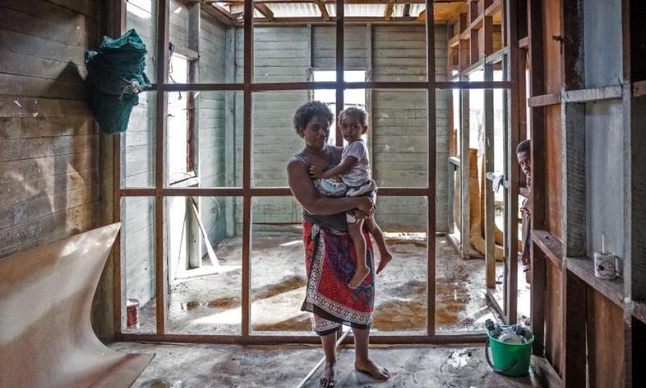 Kolora, 26, holds her daughter Semaima, 2, in what is left of her home in the aftermath of Tropical Cyclone Winston in Rakiraki district in Ra province in Fiji February 24, 2016, in this picture supplied by UNICEF. Photo: Sokhin, Reuters