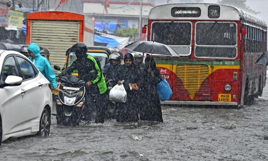 People walk through a flooded road at Andheri in Mumbai on Tuesday, August 29, 2017. Photo: Shashi S Kashyap