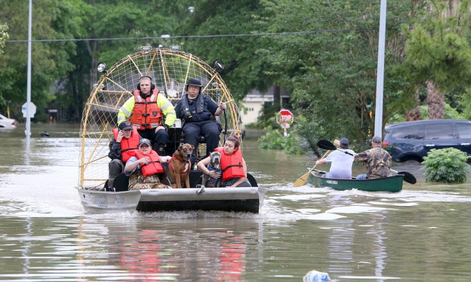 People and their pets are rescued from their homes near Nanes at Baltic in Houston, Texas, Wednesday, April 20, 2016.Thousands of people have been evacuated from their homes and major highways were closed after the rains that started Sunday overwhelmed Houston's bayous. Forecasters have issued another flash flood watch for Houston through Wednesday night. Photo: Steve Gonzales/Houston Chronicle via AP