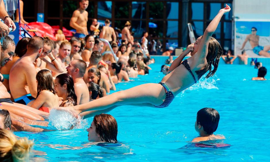 A girl jumps into a public pool in Belgrade to escape temperatures exceeding 100 degrees. Photo: Pedja Milosavljevic, AFP/Getty Images