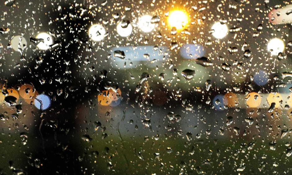 A silhouetted pedestrian is seen through raindrops on a car window as they make their way along Lake Merritt in Oakland, Calif., on Tuesday, February 12, 2019. An atmospheric river is descending on the Bay Area, with rain expected to fall through Thursday. Photo: Carlos Avila Gonzalez, San Francisco Chronicle