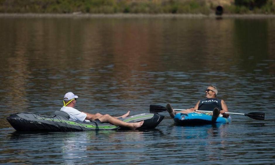 A just-retired Mark Wilson of East Sacramento, left, relaxes in a kayak while floating in Lake Natoma with his friend Danny Langdon of Tahoe Park on Thursday, August 3, 2017 in Sacramento, Calif. Sacramento set a heat-wave record Monday with 41 consecutive days at 90 degrees or warmer. Photo: Randy Pench
