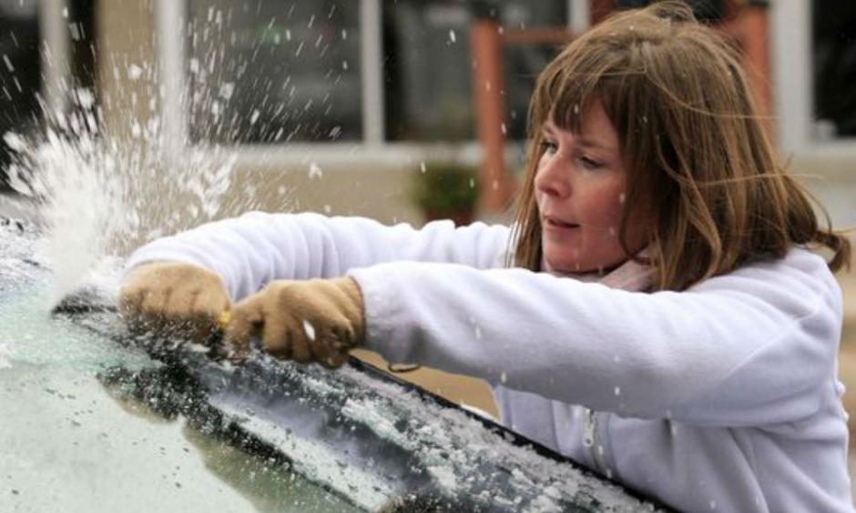 Krystal Wright scrapes ice from her car's windshield Friday, Nov. 27, 2015 in Wichita, Kan. The winter weather left a layer of ice on roads and cars early Friday morning after a heavy rain on Thanksgiving day that set a record with over 2 inches of rain. Photo: Brian Corn, The Wichita Eagle via AP