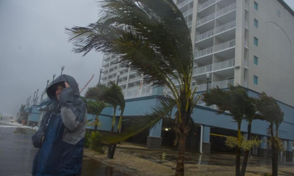 Monica Martin watches the pounding surf from the boardwalk as Hurricane Sandy approaches Ocean City. Photo: Ricky Carioti/The Washington Post