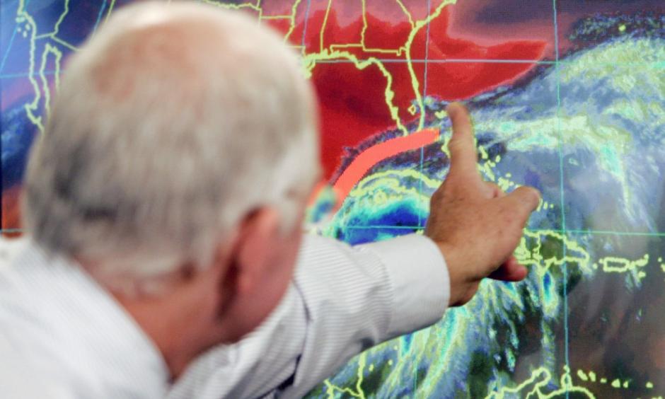 In this Oct. 19, 2005 file photo, Max Mayfield, the former director of the hurricane center (now retired), draws a line showing one of the possible trajectories of Hurricane Wilma in Miami. It’s not just this year. The monster hurricanes Harvey, Irma, Maria, Jose and now Lee that have raged across the Atlantic are contributing to what appears to be the most active period for major storms on record. Photo: Alan Diaz, AP