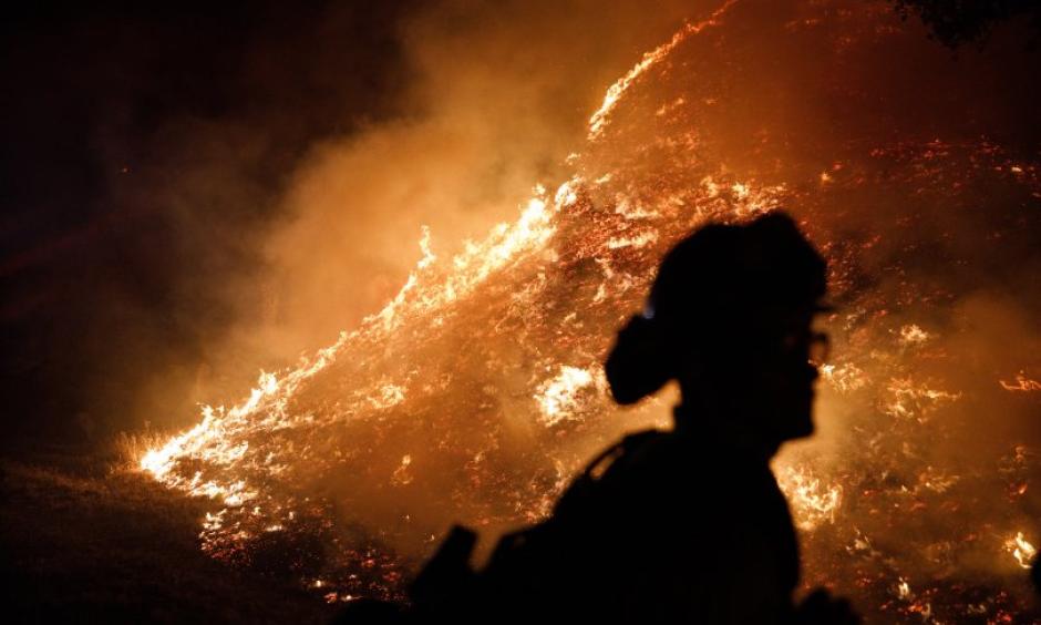 Firefighters stand watch by a fire line along Mayacama Club Drive as the Kincade Fire burns in the outskirts of Santa Rosa, Calif., on Oct. 28, 2019. Credit: Dai Sugano/Bay Area News Group