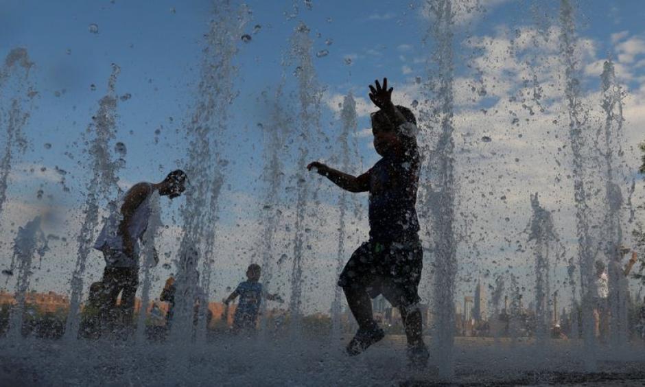 Children beat the heat in New York on Sunday in Brooklyn’s Domino Park waterworks. Credit: Andrew Kelly, Reuters