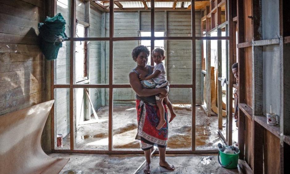 Kolora, 26, holds her daughter Semaima, 2, in what is left of her home in the aftermath of Tropical Cyclone Winston in Rakiraki district in Ra province of Fiji. Photo: UNICE