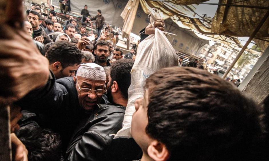 Aleppo residents clamor for aid at food distribution point of the UN World Food Program, February 2013. Photo: Jan-Niklas Kniewel,EPA