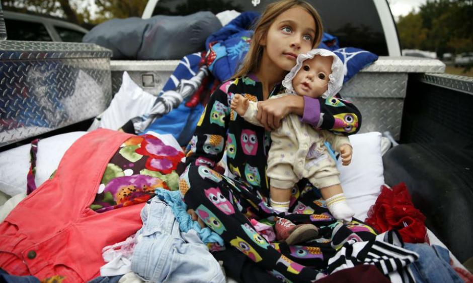 Zayann Nelson, whose family's house in Cpbb was totally destroyed by the Valley Fire, sits in the back of her family's pick up truck at the Napa County Fairgrounds in Calistoga, Calif., on Monday, September 14, 2015. Photo: Scott Strazzante, The Chronicle