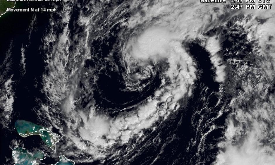 A broad loop of showers and thunderstorms is spiraling into 99L, shown here in a visible satellite image from 10:45 am EDT Friday, October 21, 2016. Image: NASA