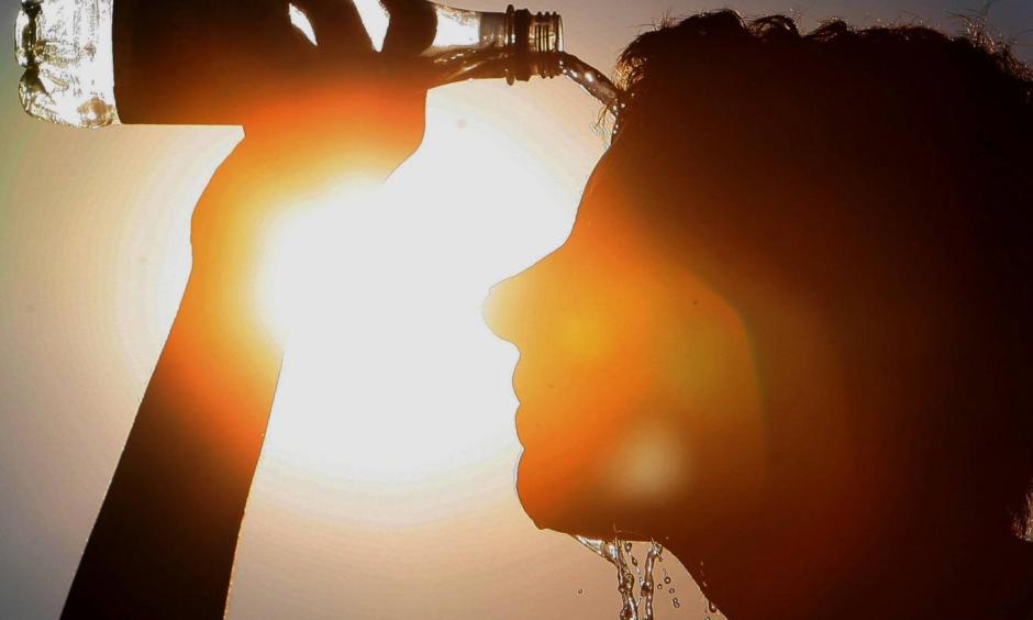 A man cools himself down. Photo: Rex Features