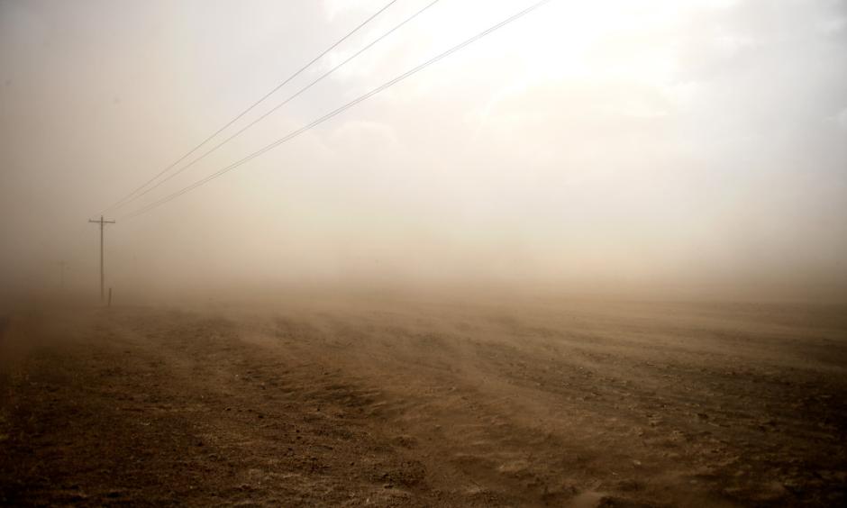 High winds blowing sand and smoke from a smoldering brush fire near the town of Haxtun in Phillips County, Colorado March 7, 2017. Photo: Joe Amon, The Denver Post