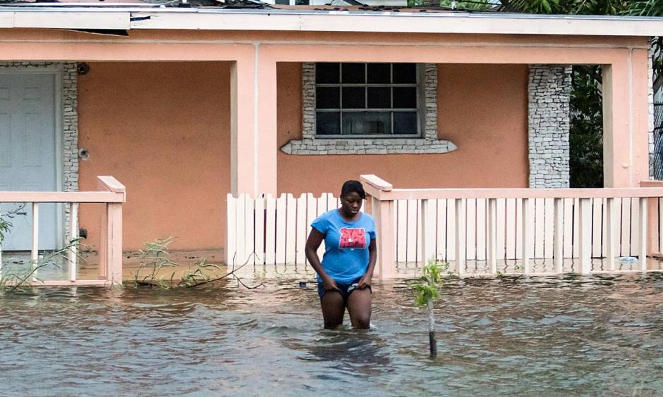 A woman walks in a flooded street after the effects of Hurricane Dorian arrived in Nassau, Bahamas. Photo: Reuters