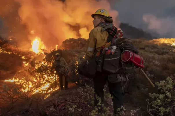 Firefighters battle the Caldor fire on August 22, 2021.